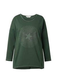 Chemise verte à manches longues en coton avec un col rond. Présente un motif à pois au centre et des fentes sur les côtés à l'ourlet.