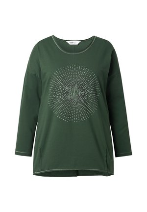 Chemise verte à manches longues en coton avec un col rond. Présente un motif à pois au centre et des fentes sur les côtés à l'ourlet.