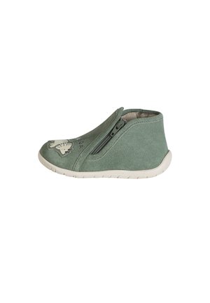 Soft green toddler shoe with side zipper, white flexible sole, and animal face design on the toe area.