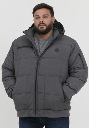 Gray puffer jacket with quilted design, hood, front zipper closure, and side pockets. Features a round logo on the chest.