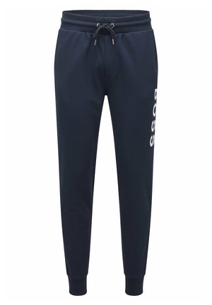 Pantalon de jogging bleu marine avec taille élastique et cordon, poignets côtelés aux chevilles, et logo blanc vertical "BOSS" sur la jambe droite.