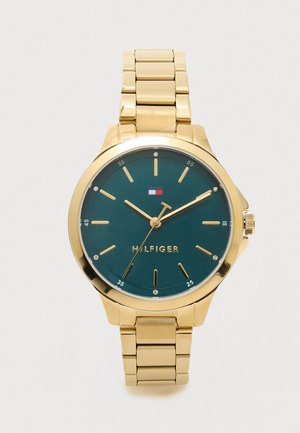 Gold-tone metal watch with a green dial, silver accents, and diamond-like markers. Features a linked bracelet and a round case design.