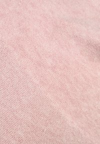 Soft pink blanket with a textured surface, made of plush fabric. It features a subtle pattern, providing a gentle, cozy appearance.