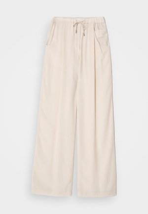 Pantaloni a gamba larga beige con vita elastica, cordoncino e due tasche laterali. Tessuto morbido con una leggera lucentezza.