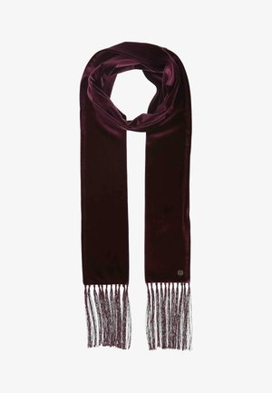 Deep burgundy velvet scarf with long fringe on both ends, looped at the top, and a small round metal logo near the fringe.