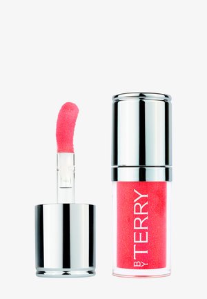 Contenant de gloss à lèvres argenté brillant avec applicateur incliné rose vif à côté.