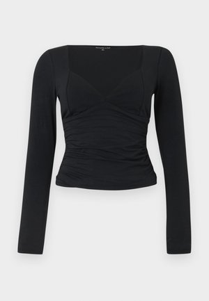 Top preto de manga longa com um design justo, decote em V e detalhe de cintura franzida. Feito de um tecido liso e elástico.