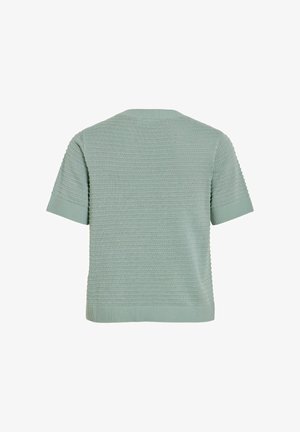 Heleroheline lühikeste varrukatega kootud kampsun, millel on tekstuuriga horisontaalne muster ning soonilised mansetid ja äär, nähtav tagantpoolt.