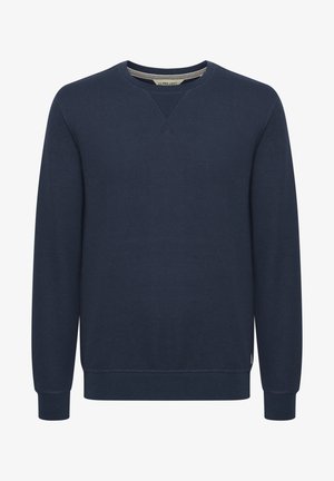 Mornarsko plava dukserica s teksturiranom tkaninom, rebrastim izrezima i izrezom na vratu. Sadrži V-oblik dizajn na okovratniku i minimalne naglaske.