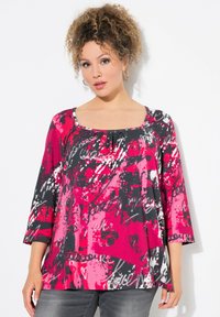 Multikleurige longsleeve top in roze, zwart en wit met een ronde hals en abstract patroon. Zachte stof met een relaxte pasvorm.