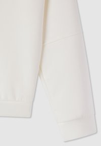 Manica di felpa color crema con texture liscia, bordo a costine e dettagli di cucitura piatta. Progettata per il comfort e la facilità di utilizzo.