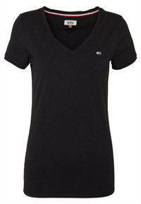 Černé tričko s výstřihem do V vyrobené z měkké bavlny s krátkými rukávy. Obsahuje malé logo na hrudi a kontrastní proužkovaný límec.