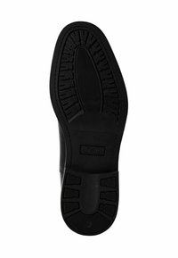 Suela de zapato negra con diseño texturizado para mayor agarre, que presenta un diseño ovalado central y un logo en relieve. El material es sintético y suave. Se indica la talla 42.