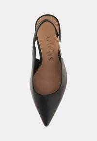 Black pointed-toe slingback shoe made of smooth leather, featuring a gold-tone metal accent and a cushioned insole with logo detail.
