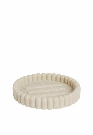 Runde beige Seifenschale mit erhöhten gerippten Rändern und Rillen am Boden zum Abfließen von Wasser.