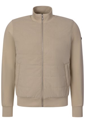 Beige lynlåsjakke med ribbet krave, manchetter og kant, med polstrede for- og sidelommer.
