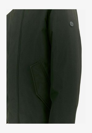 Dark green jacket made of smooth fabric with a clean design, featuring a side pocket and a circular logo on the upper arm.