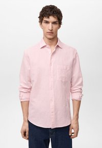 Lichtroze langemouwen shirt met een button-down kraag, een borstzak en opgerolde mouwen; gemaakt van linnen stof.