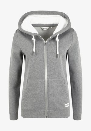 Grå lynlås hoodie med hvid faux fur foring, snøre og frontlommer. Har ribbet kant og logomærke nederst.