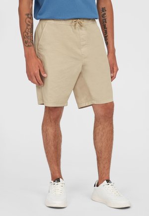 Beige shorts lavet af bomuld, med en elastisk talje og snøre, sidelommer og en lige skæring.
