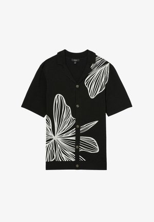 Short-sleeve black shirt featuring large white floral embroidery, buttoned front, and a spread collar. Smooth texture with casual design.