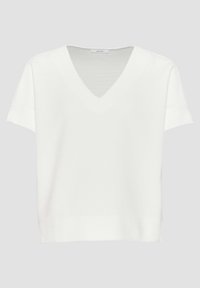 Haut blanc à manches courtes avec col en V, fabriqué en matériau texturé avec un design simple, offrant une coupe décontractée et une finition lisse.