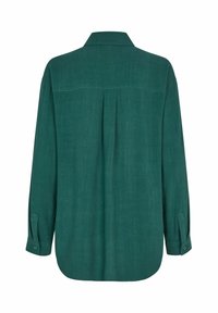 Camicia verde a maniche lunghe realizzata in tessuto testurizzato. Presenta una cucitura sul retro, polsini con bottone, orlo curvo e vestibilità rilassata.