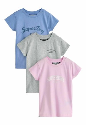Three short-sleeve t-shirts in blue, gray, and pink, each with Superdry brand text and logos on the front.