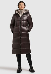 Long, dark brown quilted puffer coat with a zip front, hood, and two side pockets. Smooth, shiny fabric with a lightweight feel.