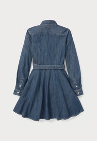 Jeansklänning med långa ärmar, en figurnära kropp, utsvängd kjol och midjebälte. Klassisk blå färg med knäppning vid ärmsluten och krage.
