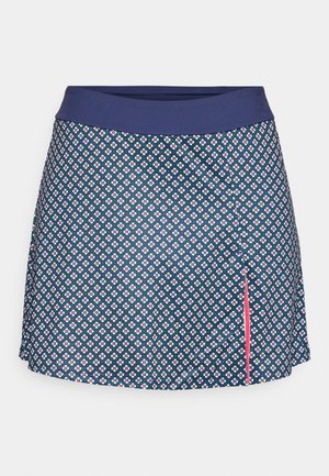 Navy blue skirt with small white and red floral pattern, wide solid navy waistband, and a side slit with pink trim.