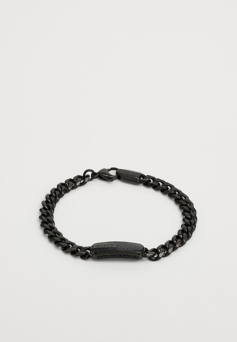 Bracelet en chaîne noire avec des maillons polis, un accent central texturé et un fermoir à bascule. Fabriqué en métal avec une finition lisse.