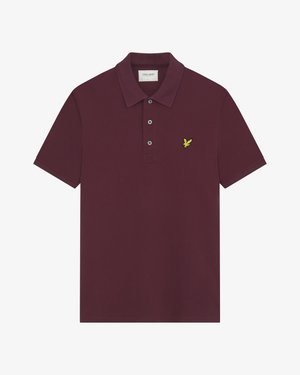 Polo bordeaux en coton. Il présente un col à deux boutons, des manches courtes et un logo aigle brodé jaune sur la poitrine gauche.