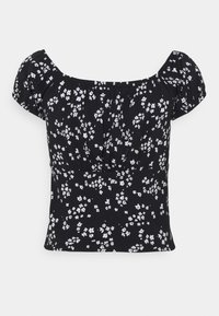 Musta lyhythihainen crop-top, jossa on valkoisia pieniä kukkakuviota ja poimuttunut kaula- ja vyötäröosa yksinkertaisella taustalla.