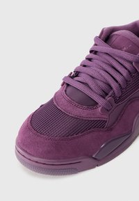 Μωβ αθλητικά παπούτσια με σουέτ και ύφασμα διχτυού, στρογγυλή μύτη, επενδεδυμένος κολάρος και επίπεδα κορδόνια. Διαθέτουν υφασμάτινη σόλα με υφή και λεπτομέρειες με λογότυπο.