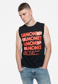 Black, sleeveless t-shirt featuring bold red graphic text: "RAMONES LIVE", with event details in smaller text at the bottom.