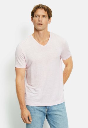 Light pink short-sleeve V-neck T-shirt made of soft fabric, paired with light blue denim jeans. Simple design with a casual fit.