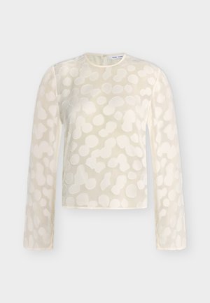 Κρεμ μπλούζα με μακριά μανίκια, ανάγλυφο αφηρημένο πουά μοτίβο, στρογγυλή λαιμόκοψη και κλείσιμο με κουμπιά στην πλάτη.