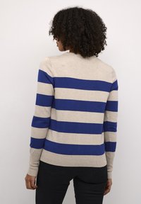 Beige sweater with bold blue and gray horizontal stripes, long sleeves, ribbed hem and cuffs, round neckline, and soft knit texture.