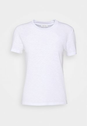 T-shirt bianco in cotone con colletto rotondo, maniche corte e superficie leggermente texture. Nessun motivo o accessorio visibile.