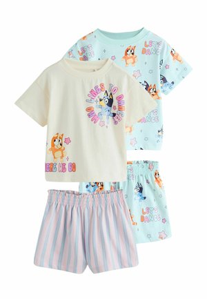 Two sets of children's pajamas: one cream shirt with cartoon dog and text, striped pink and blue shorts; one light blue shirt and shorts with dog and "Let's Dance" pattern.