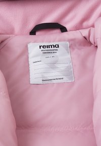 Roze unutarnje podstave jakne s etiketom za njegu. Etiketa glasi "reima," uključuje veličinu 104/4T i "Molim te, proslijedi me dalje!"