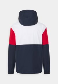 Marinblå, vit och röd huva-jacka med långa ärmar, med en färgblockerad design och elastiska manschetter. Slät, lätt tyg.