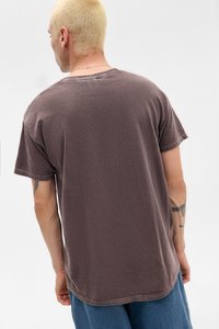 Brown short-sleeve T-shirt with a relaxed fit and textured fabric. Features a round neckline and visible stitching detail at the hem.