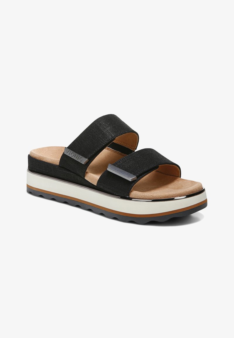 Sandale noire à bout ouvert avec deux larges brides en tissu, première de propreté marron rembourrée et semelle blanche épaisse avec des couches marron et noire.