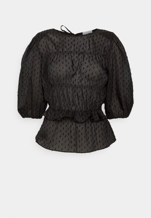 Blusa nera testurizzata con maniche a sbuffo, vita arricciata e orlo con volant. Tessuto leggero con piccoli punti in rilievo su tutta la superficie.