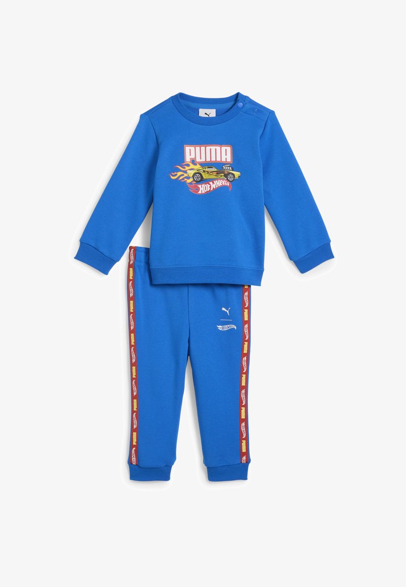 Zestaw dresowy z niebieską bluzą i spodniami Puma. Bluza ma grafikę samochodu i zatrzaski; spodnie mają boczne paski z wzorami samochodów. Wytrzymały materiał.