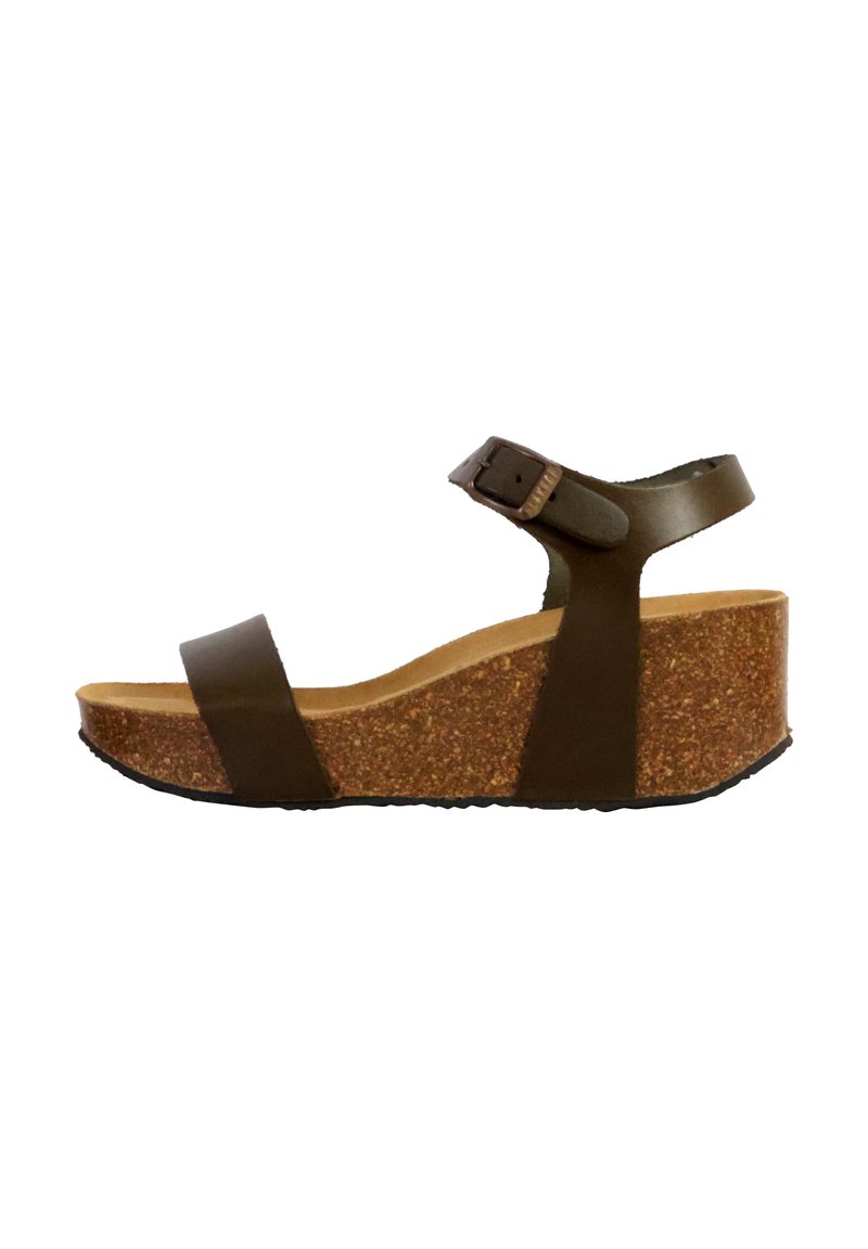 Sandale compensée en cuir marron avec plateforme en liège ; elle présente deux lanières sur le pied et une lanière de cheville réglable. Semelle en caoutchouc pour une meilleure adhérence.