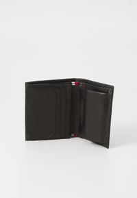 Black leather wallet with a textured finish. Features multiple card slots, a clear slot, and a small accent in red and white. Folded design.