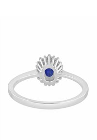 Anillo de plata con una piedra azul redonda engastada en un diseño texturizado que asemeja una flor en la parte superior. La banda es lisa y delgada.